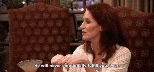 a woman is sitting at a table with a martini and says he will never emotionally fulfill you ever