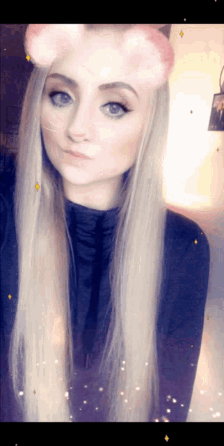 a woman with long blonde hair wearing a cat ear mask