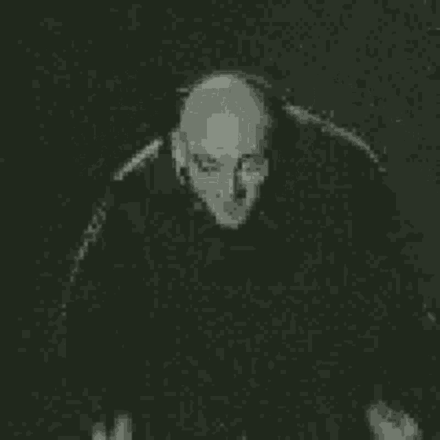 a black and white photo of a man with glowing eyes .