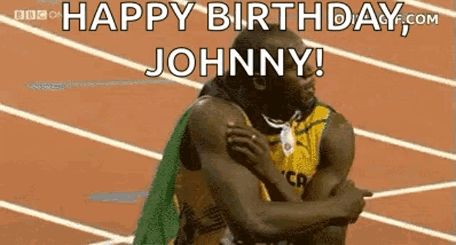 a man is hugging another man on a track and says `` happy birthday johnny ! ''