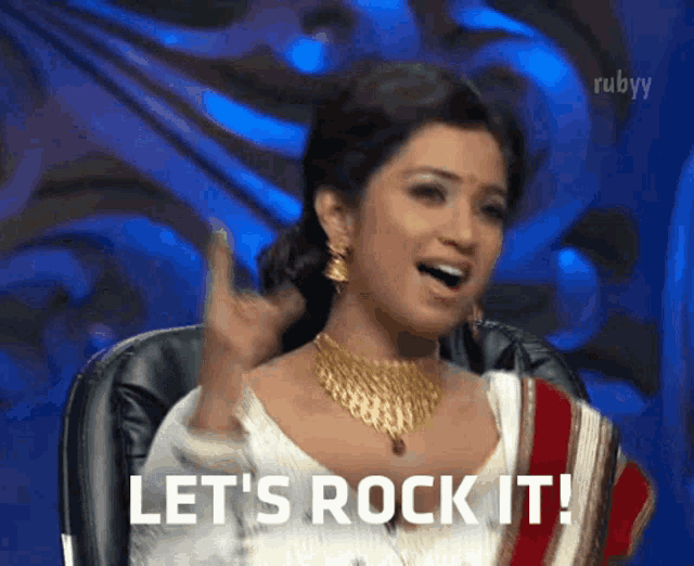 a woman says let 's rock it while sitting on a chair
