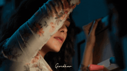 a close up of a woman 's face with the name giridhar below her