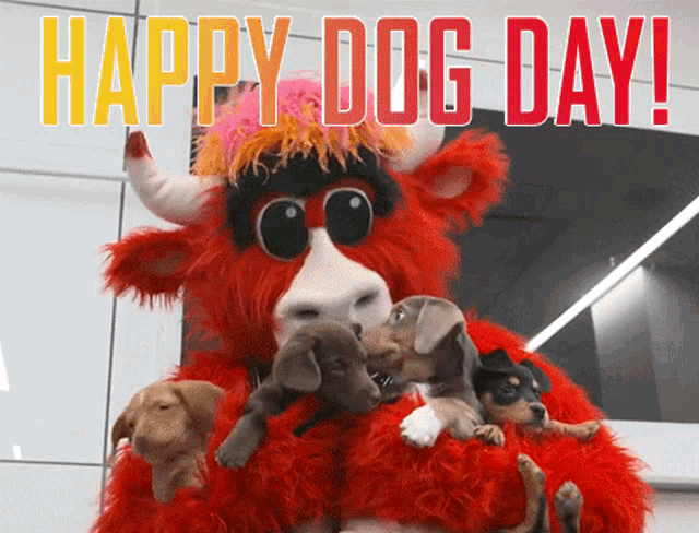 a red bull mascot is holding puppies and the words happy dog day are above him