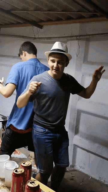 a man wearing a white hat is standing next to another man