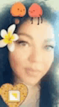 a close up of a woman wearing a flower crown and a heart .