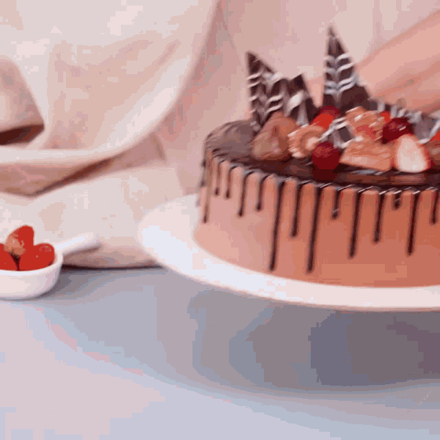 a chocolate cake with strawberries on top is on a plate