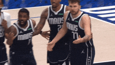 a group of basketball players wearing maus jerseys on a court