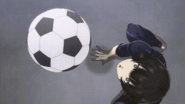 a person is kicking a soccer ball in the air while doing a trick .