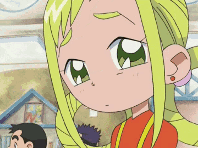 a little girl with blonde hair and green eyes looks sad