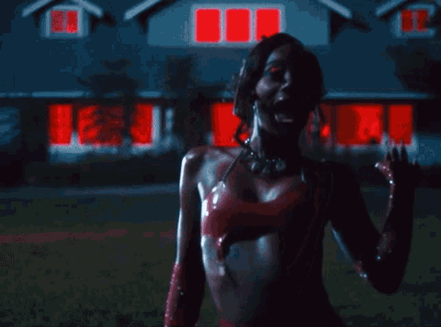 a woman in a red bikini is standing in front of a house with red lights on