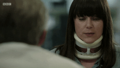 a woman with a brace on her neck is talking to a man on bbc