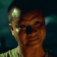 a close up of a man 's face with a shadow on his forehead