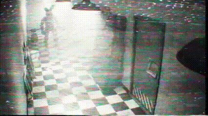 a black and white photo of a hallway with checkered floors