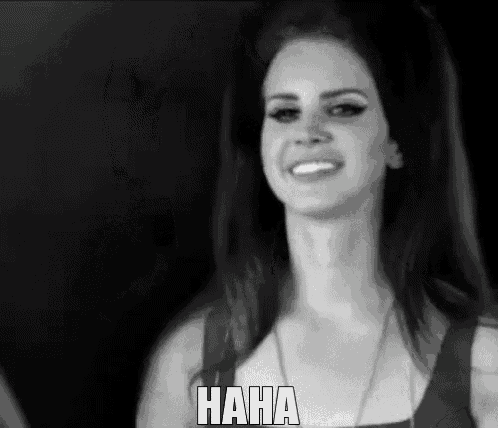 a woman is smiling in a black and white photo with the word haha on the bottom right
