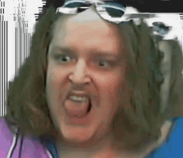 a woman with long hair and sunglasses is making a funny face .