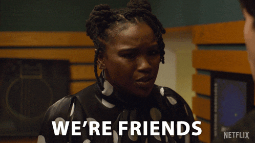 a woman in a black and white polka dot shirt says we 're friends