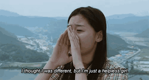 a woman covering her face with her hands with the words " i thought i was different but i 'm just a helpless girl "