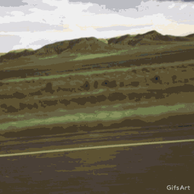 a gif of a car driving down a road with a yellow line