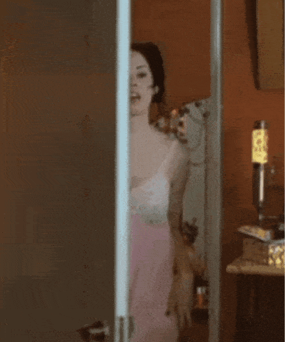 a woman in a pink dress stands in front of a mirror with the words self care day written above her
