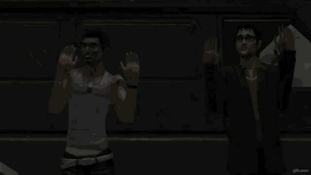 two men are standing next to each other in a dark room with gifs.com in the corner