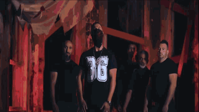 a man wearing a mask and a shirt that says 36