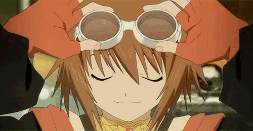 a close up of a girl wearing goggles on her head