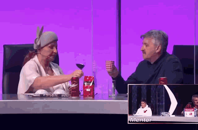 a man and a woman are sitting at a table with a can of pringles in front of them