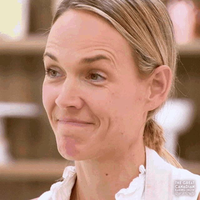 a close up of a woman 's face with the words " the great british baking show " on the bottom right