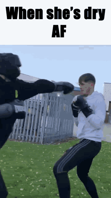 a man in boxing gloves is standing next to another man with the caption " when she 's dry af " on top