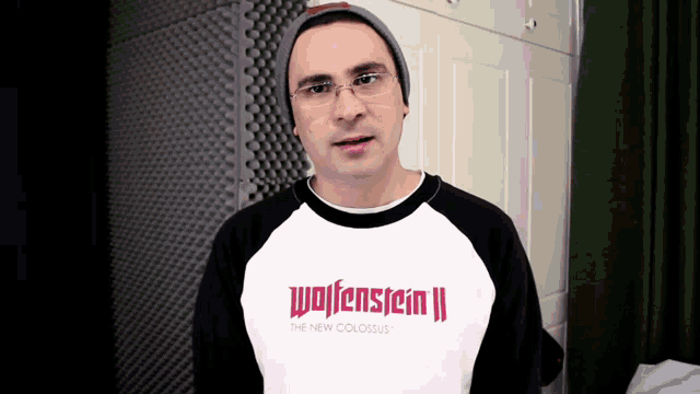 a man is wearing a wolfenstein ii sweatshirt