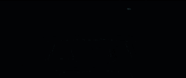 a man is driving a car in a dark room with the windshield open .