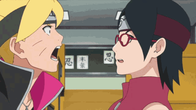 a boy and a girl are looking at each other with chinese writing on the wall behind them