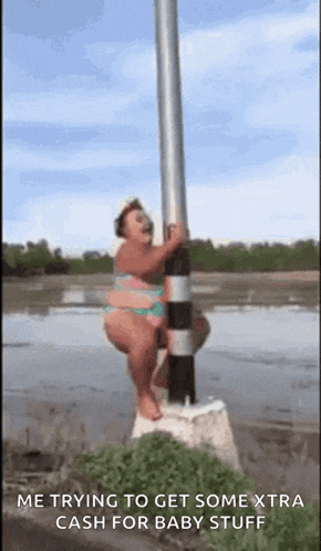 a woman in a bikini is standing on a pole in the water .