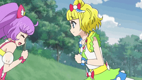 two anime girls are standing next to each other in a park