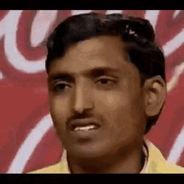 a close up of a man 's face with a red background .