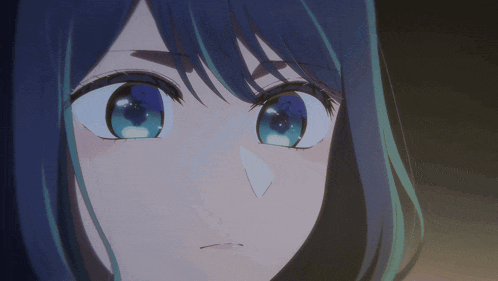 a close up of a woman 's face with blue eyes