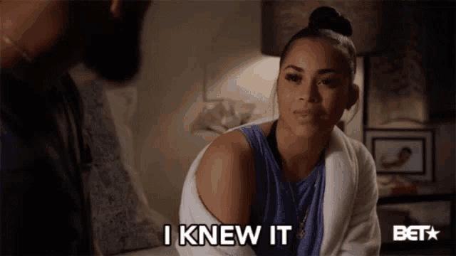 a woman in a bathrobe says i knew it in front of a man