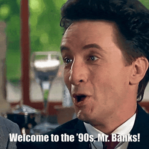 a man in a suit says welcome to the 90s mr. banks