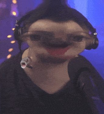 a close up of a person wearing headphones and making a face