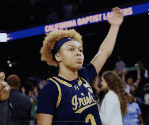 a female basketball player wearing a jersey with the number 3 on it