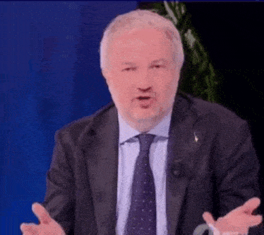 a man in a suit and tie says tutto li.