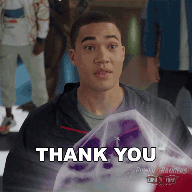 a power rangers ad with a man holding a purple object that says " thank you "
