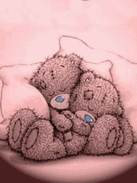 two teddy bears are hugging each other while sitting on a bed .