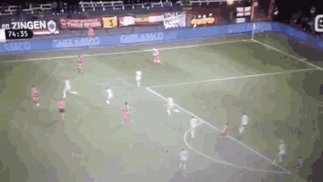 a soccer game is being played on a field with a sign that says zingen