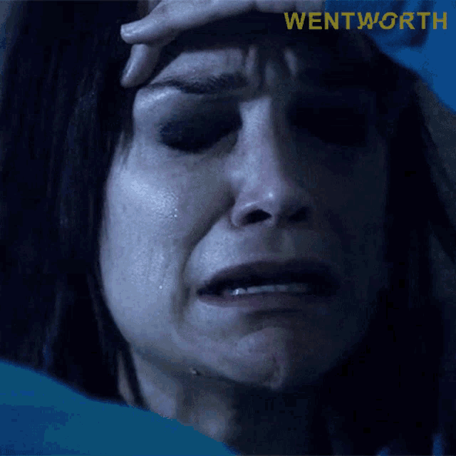 a close up of a woman 's face with the word wentworth on the bottom right