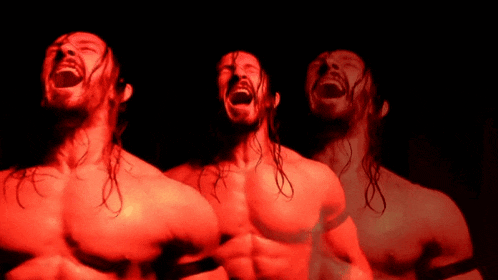a man without a shirt is screaming in red light