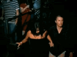 a group of people dancing in a dark room