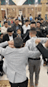 a group of people are standing in a circle holding hands .