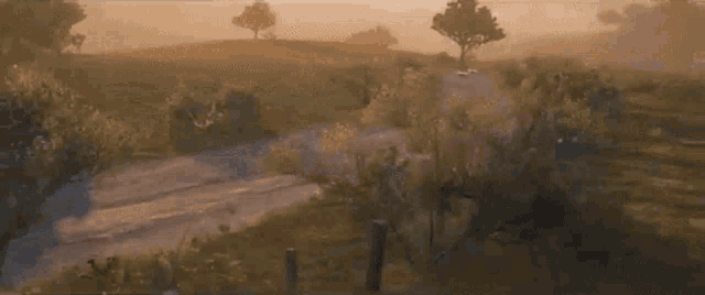 a red sports car is driving down a dirt road