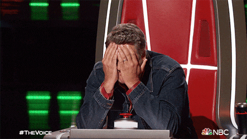 a man sits in a chair with his hands on his face and a nbc logo on the bottom